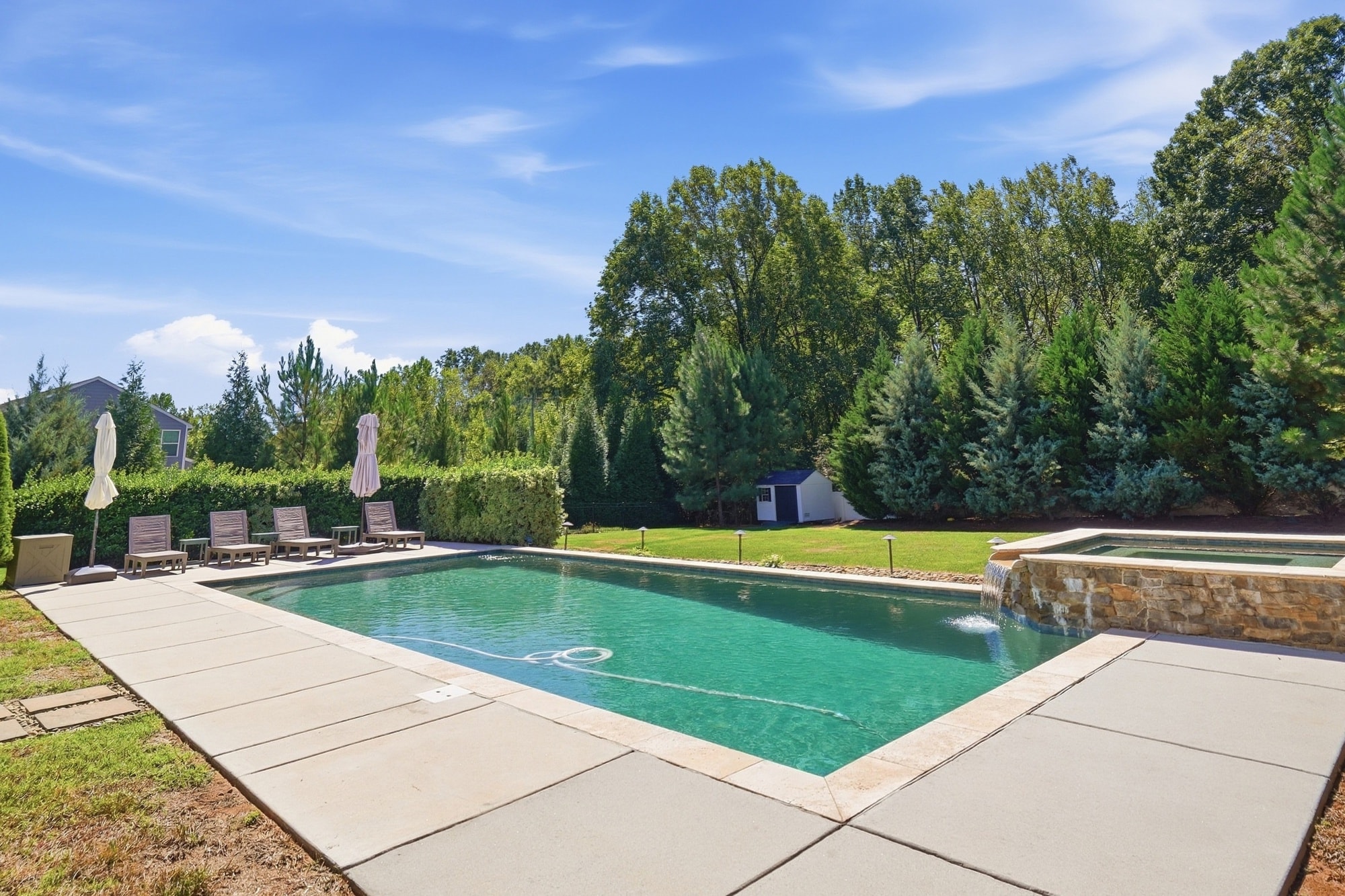 Pool and spa with storage shed visible in the background at 912 Manorwood Drive, Waxhaw NC